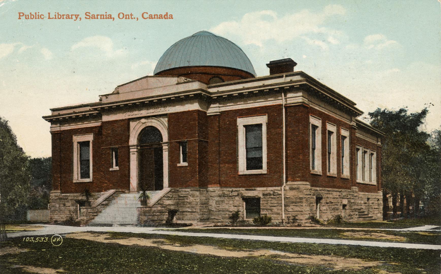 Picture of a brick and stone one storey library building with dome.