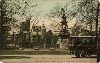 Colour photo postcard depicting a concrete monument with the Queen's Park building depicted in  ...