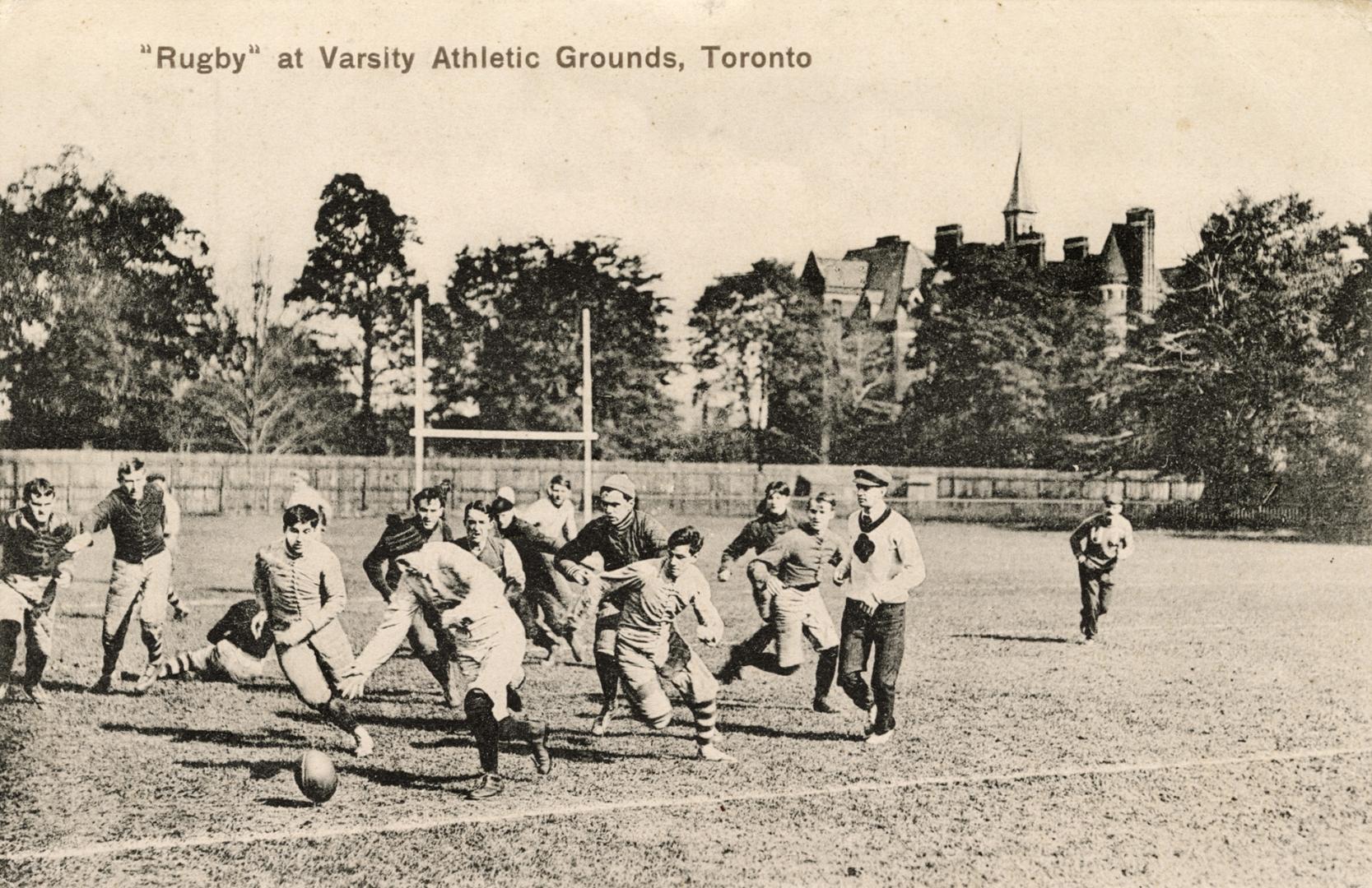 Black and white photo postcard depicting male rugby players in action. The caption at the top s ...