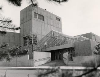 Picture of concrete library building from front entrance. 