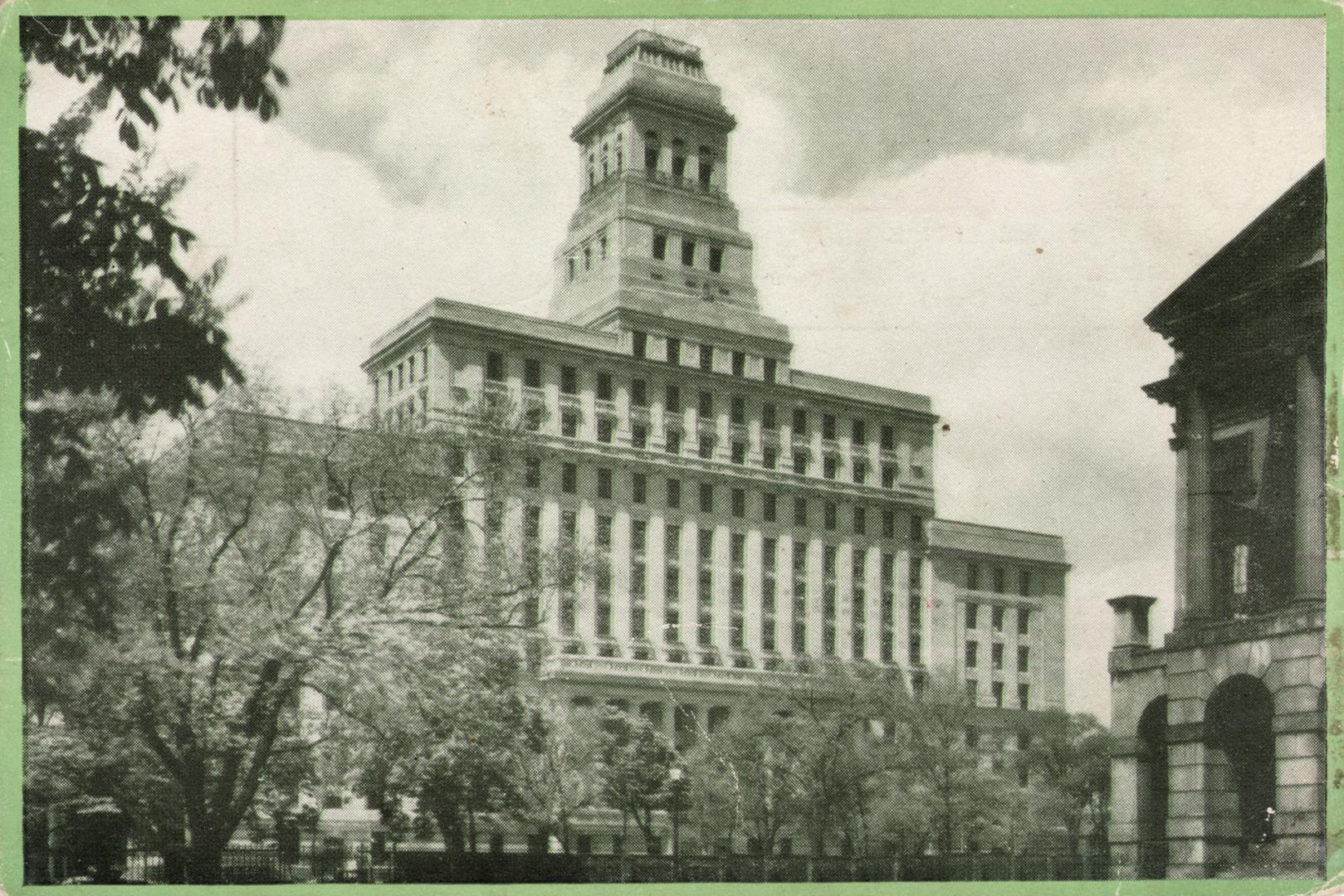 Black and white photograph of a huge Beaux Arts building with trees on the street in front of i ...