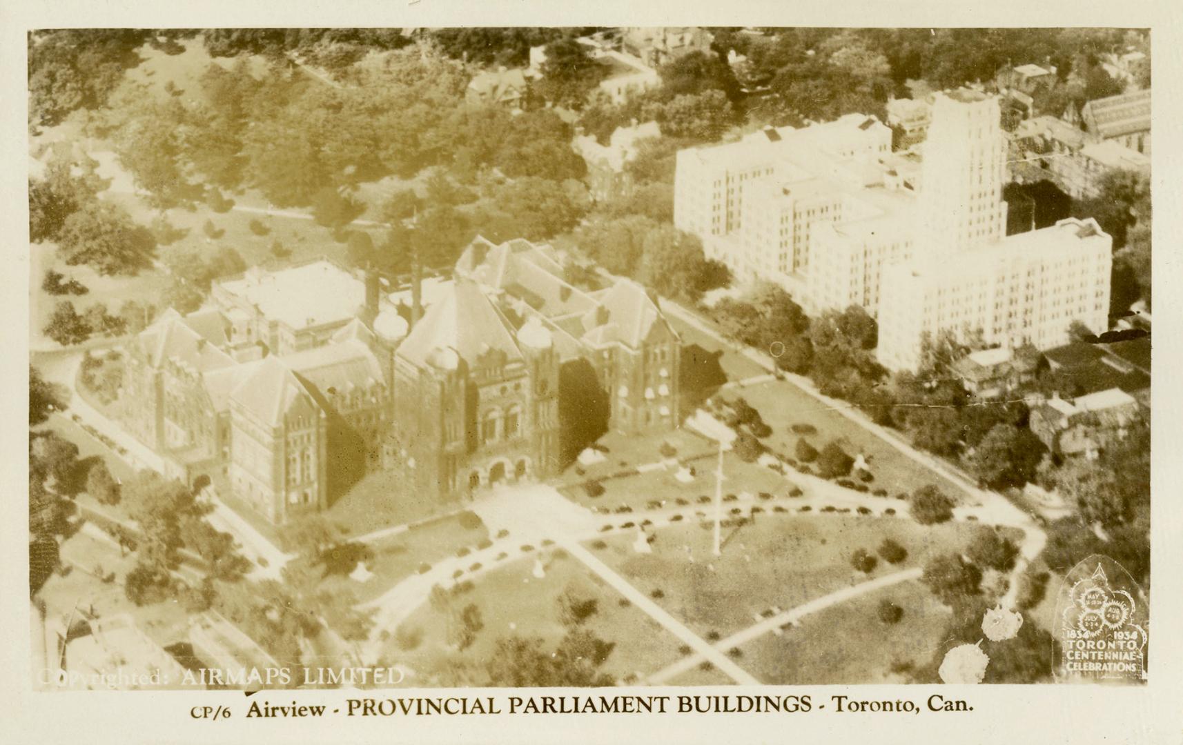 Black and white picture of a large building with turrets, taken form the air.