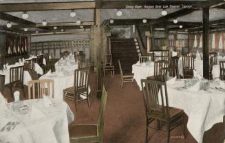 Colorized photograph of formally set tables in a room with a low ceiling.