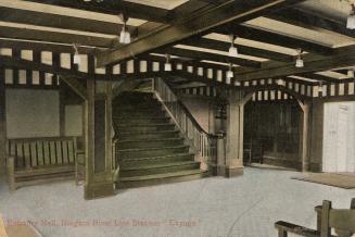 Colorized photograph of wide staircase in a room with oak beams on the ceiling