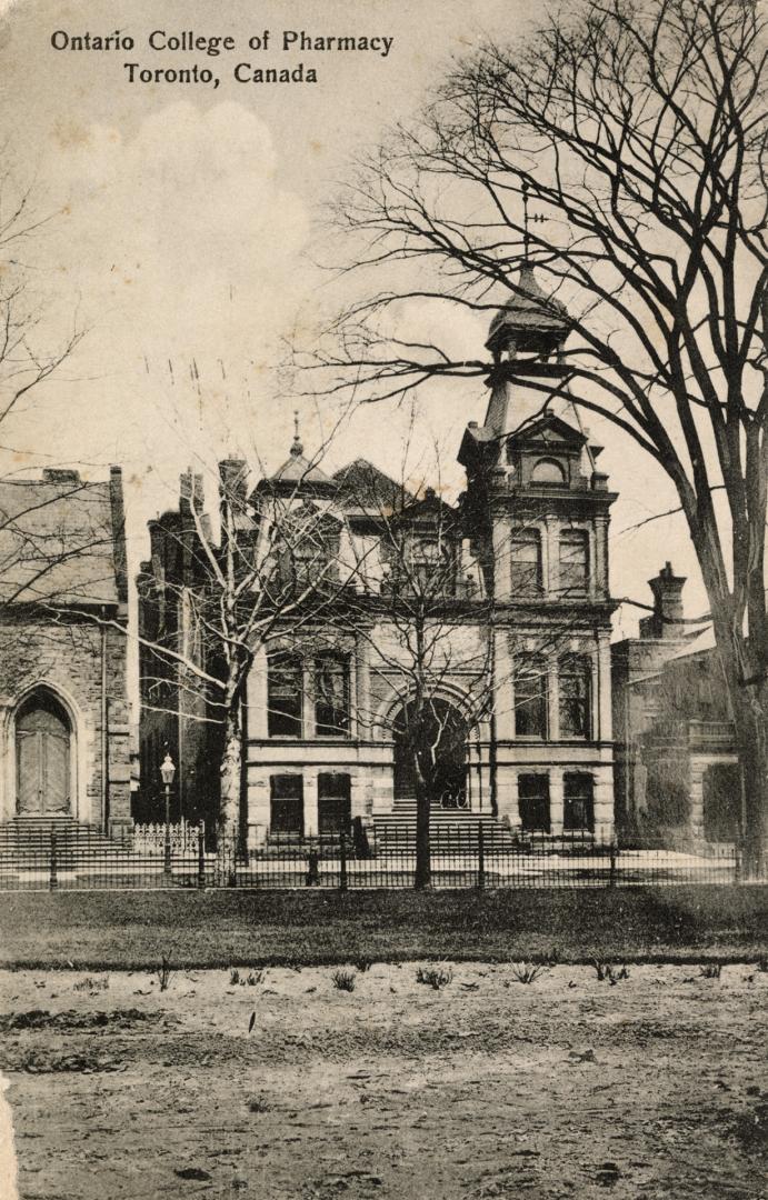 Black and white photograph of a large, Victorian, collegiate building with a turret.