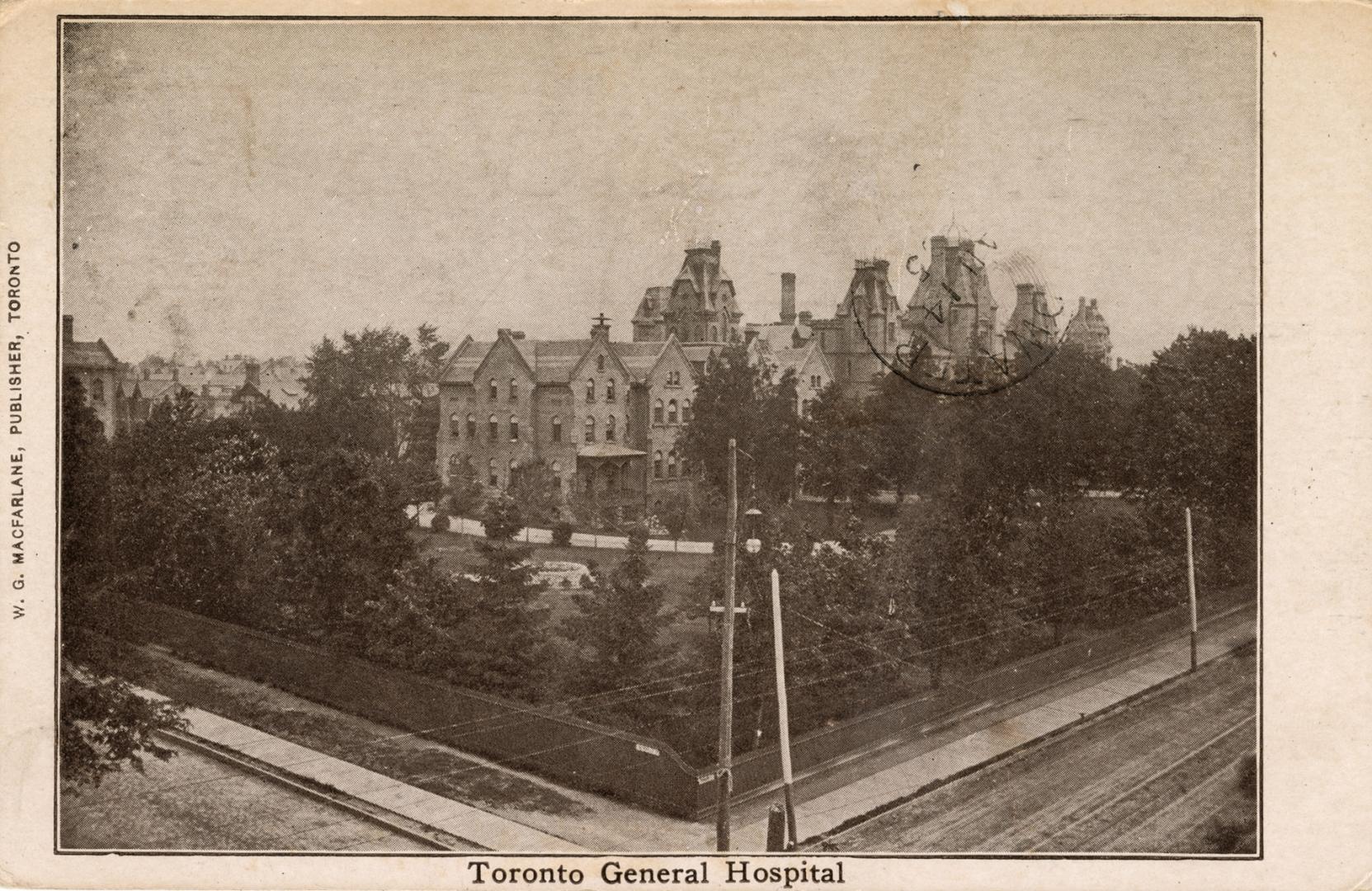 Black and white photograph of a huge hospital complex surrounded by trees.