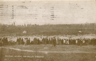 Sepia-toned photo postcard depicting many military personnel in a large field at Don Valley wit ...