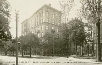 Black and while photograph of a six story, U-shaped building