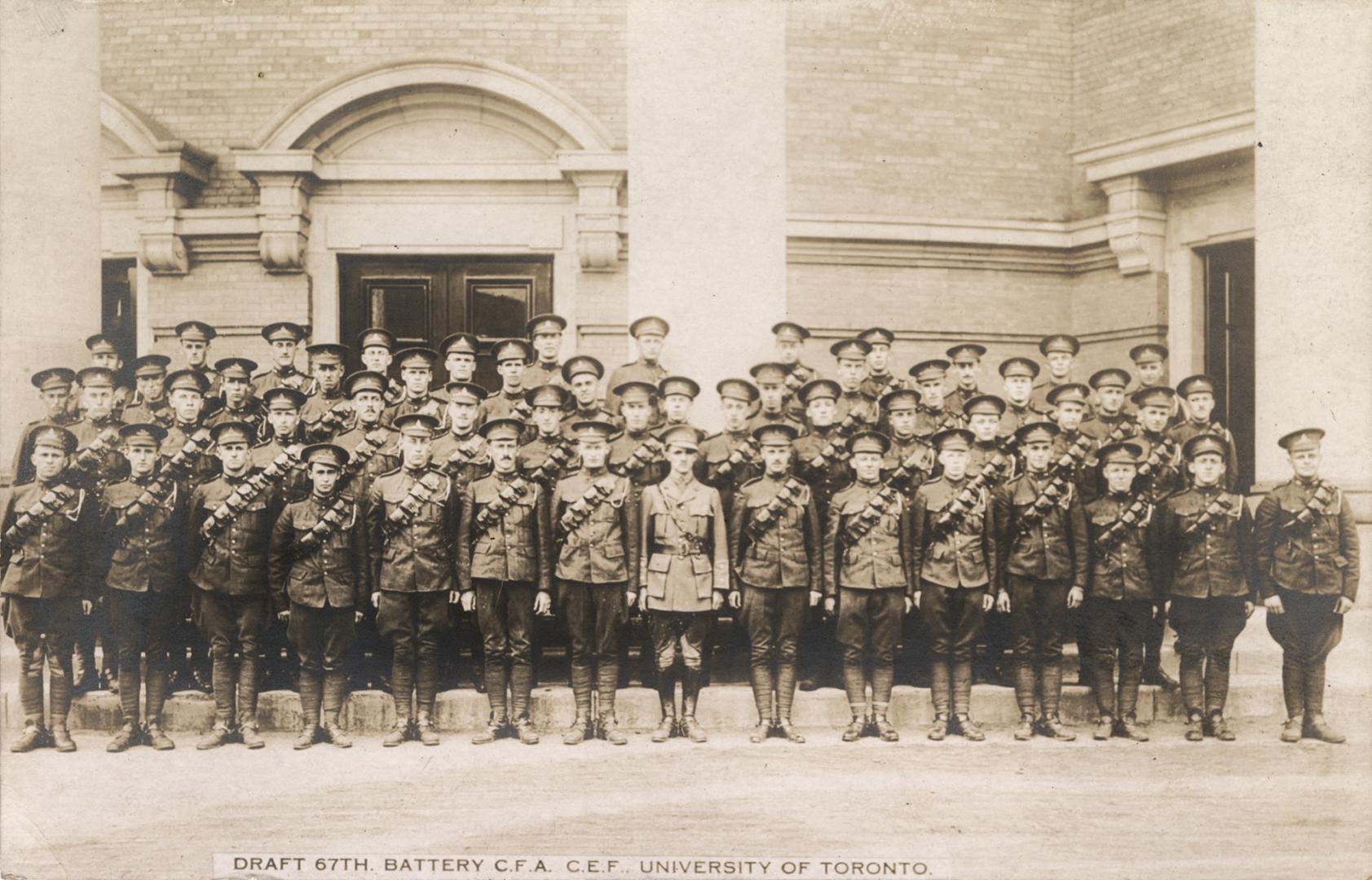 Black and white photograph of soldiers in uniform standing in lines in front of a public buildi ...