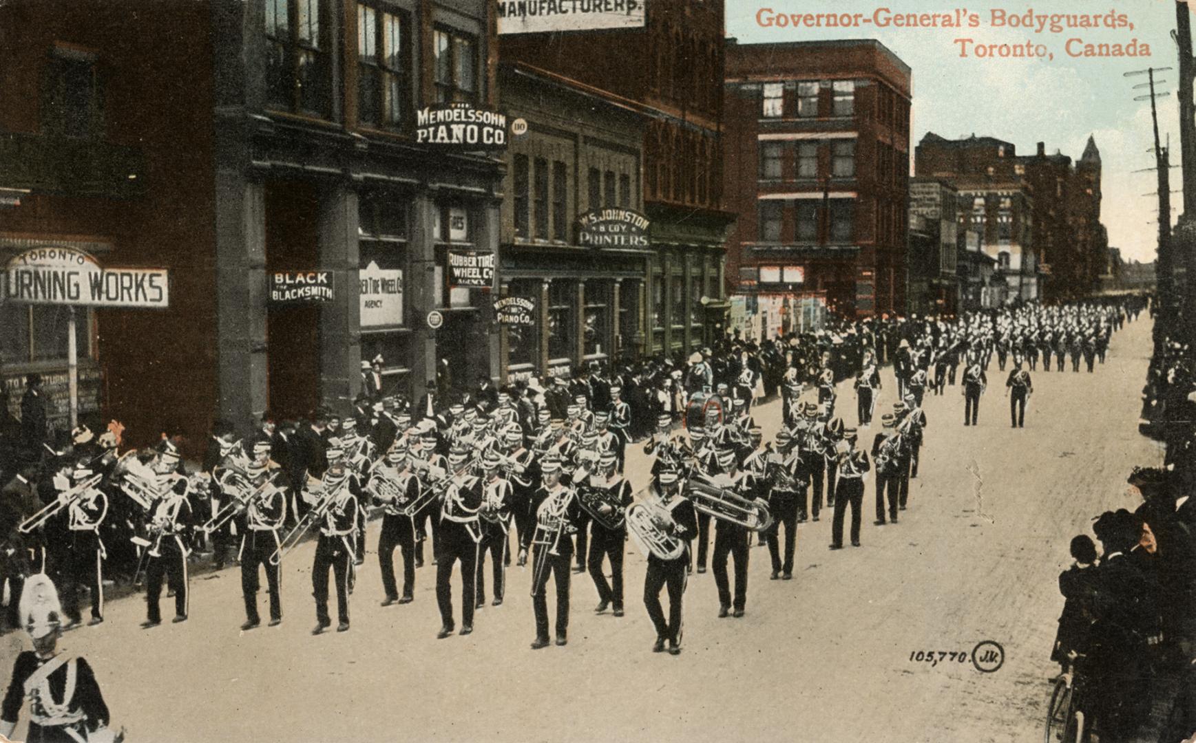 Colorized photograph of men in military uniforms parading on a city street playing musical inst…