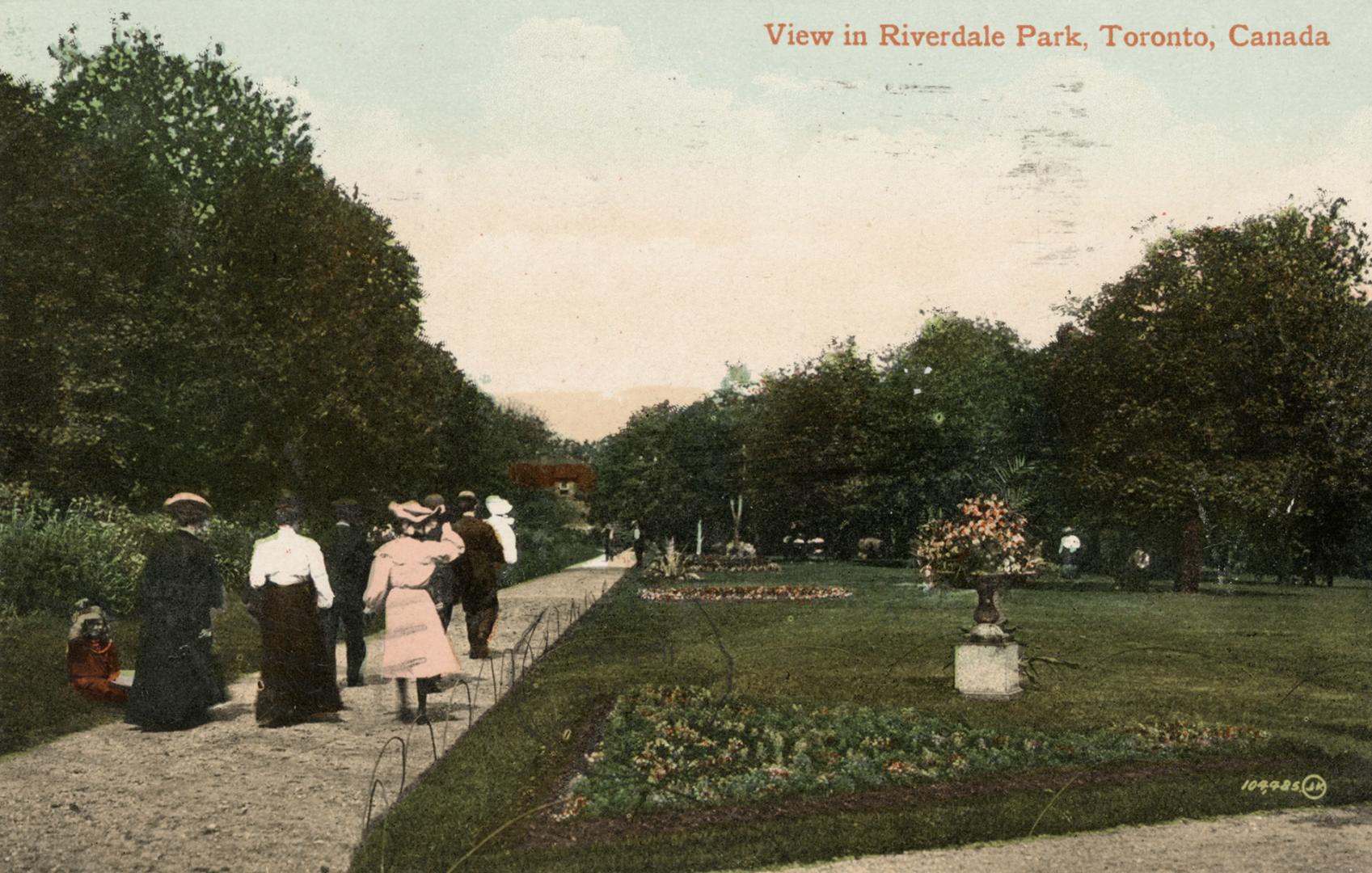 Colorized photograph of people walking on a path through a manicured park. 