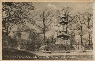 Sepia-toned photo postcard depicting a statue in a wooded / park area. The caption at the botto ...