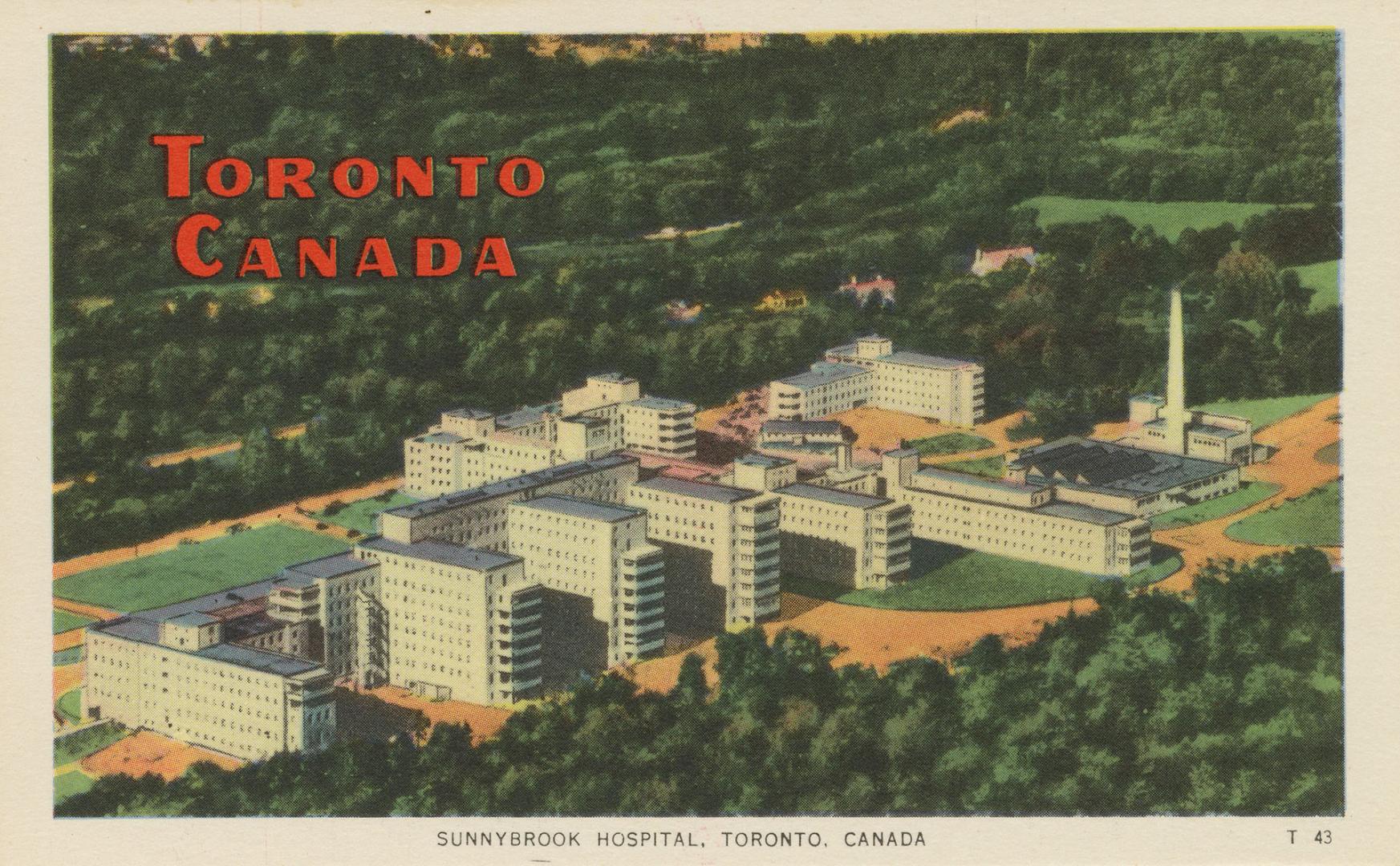 Colorized photograph, aerial shot of a hospital complex in the woods.