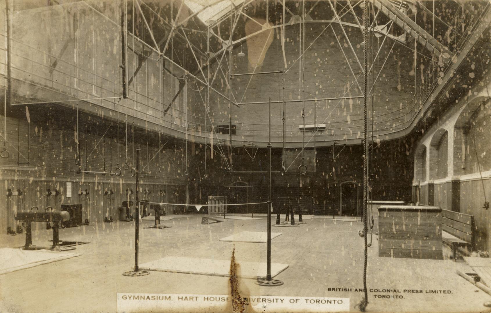 Black and white photograph of vaulting equipment set up in an empty gymnasium.