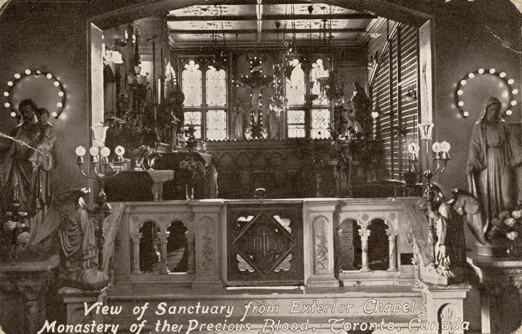 Black and photo postcard depicting a religious nook adorned with Catholic ornaments. The captio ...