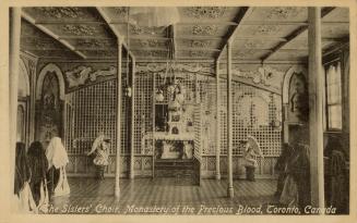 Black and photo postcard depicting a religious room with several nuns standing on the sides. Th ...