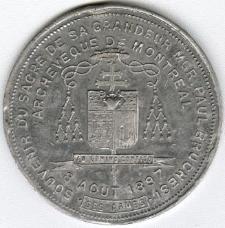 Aluminum medal.(obverse) Episcopal coat of arms with surrounding inscription, "SOUVENIR DU SACR ...