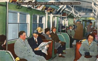 Colour photo postcard depicting the interior of a subway train with passengers sitting and stan ...