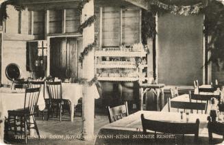 Black and white photograph and tables and chairs set up to a meal in a wood paneled dining room ...