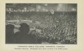 Black and white photograph of a huge crowd gathered in an auditorium.