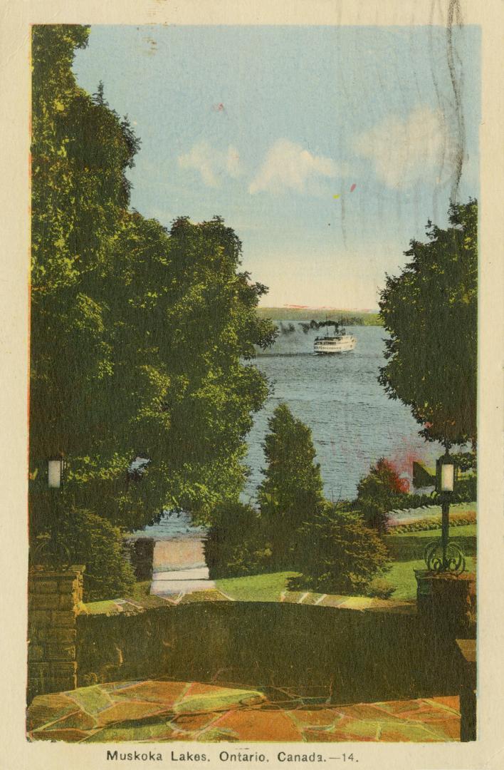 Colorized photograph of a large resort building on the edge of a smooth waterway.