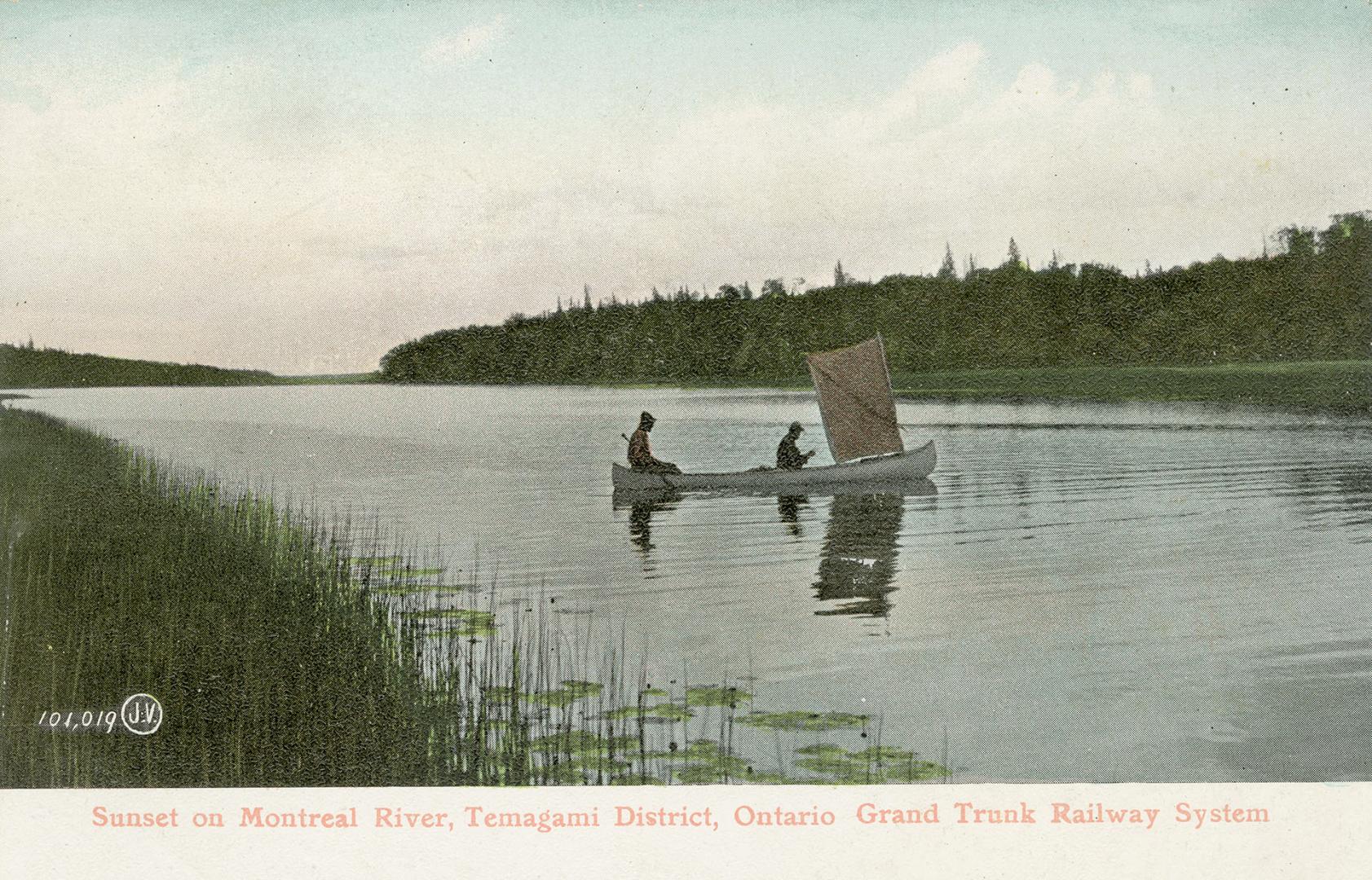 Colorized photograph of two men paddling a canoe with a sail. Water is surrounded by wilderness ...