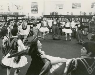 Picture of a group of dancers in a large circle. 