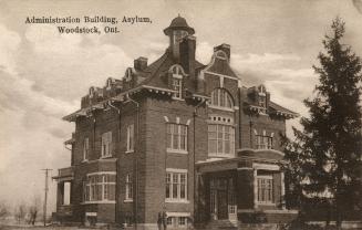 Black and white photograph of a large, three story collegiate building.