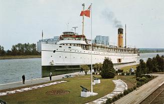 Color photograph of a large boat docked.