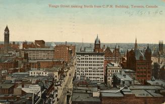 Colour postcard depicting a raised view of a city with many buildings, towers, and a main stree ...