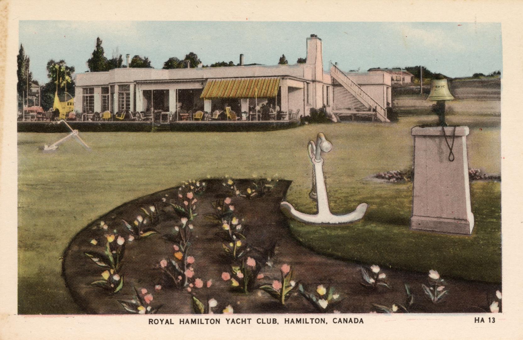 Colorized photograph of an urban garden, anchor and bell in front of a public building.