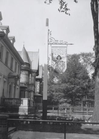 Photo of library building and large tree. 