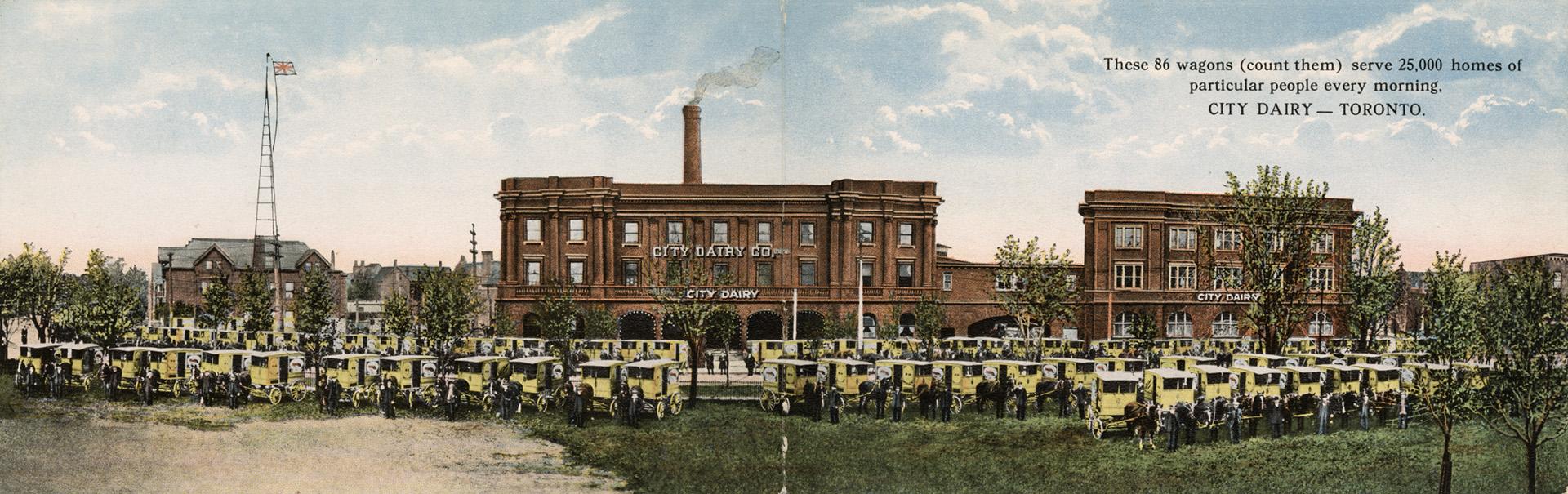 Colour folded postcard that opens up to depict a panoramic photo of three brown buildings and 8…