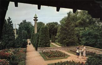 Color photograph of formal gardens within stone walls.