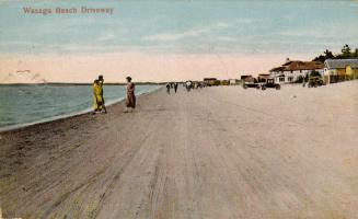 Colorized photograph of people and automobiles on a beach.
