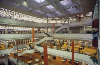 Interior view of atrium of large multi-storey library with curving balconies and staircases and…