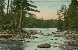 Color photograph of people in canoes on a river surrounded by trees.