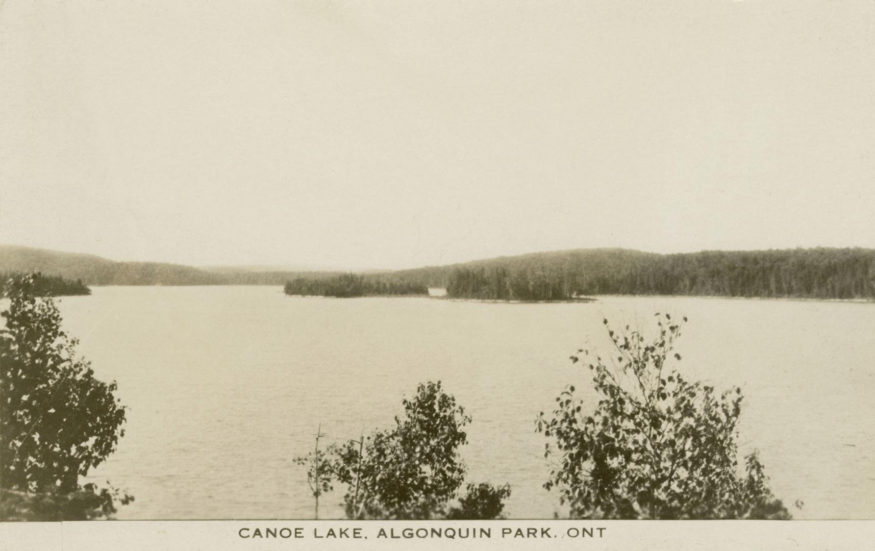 Black and white photograph of a large body of water with islands in the middle of it.