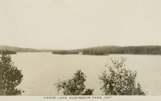 Black and white photograph of a large body of water with islands in the middle of it.