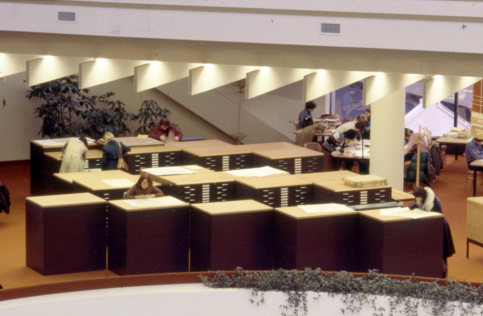 Picture of multiple black map cabinets in a library. 