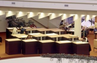 Picture of multiple black map cabinets in a library. 
