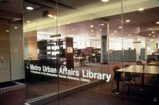 Picture of a tables and shelves in a library. 