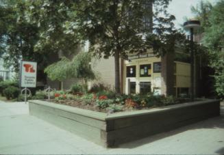 Exterior view of a public library with Toronto Public Library sign at front. 