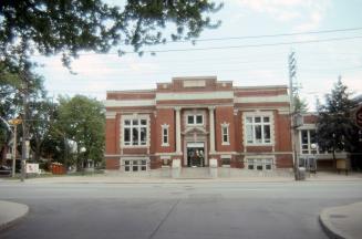 Exterior view of a public library with Toronto Public Library sign at front. 