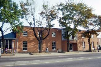 Exterior view of a public library with Toronto Public Library sign at front. 