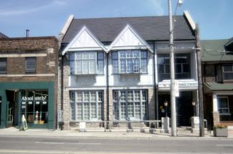 Exterior view of a public library with Toronto Public Library sign at front. 