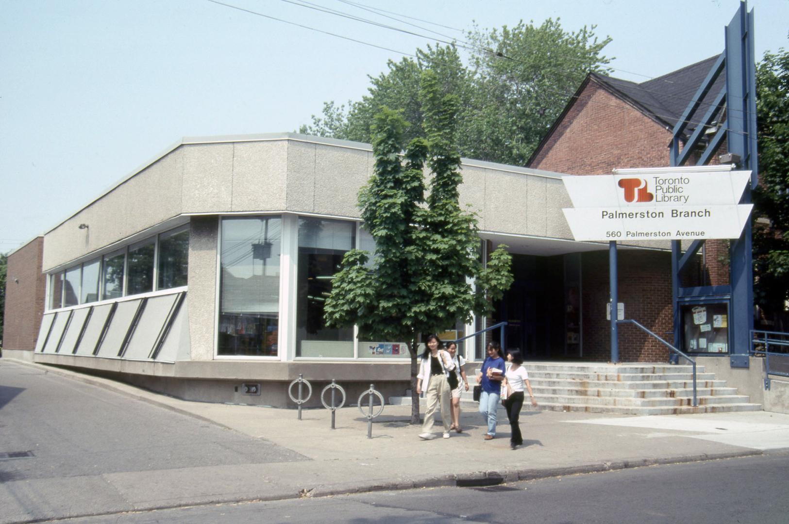 Exterior view of a public library with Toronto Public Library sign at front. 