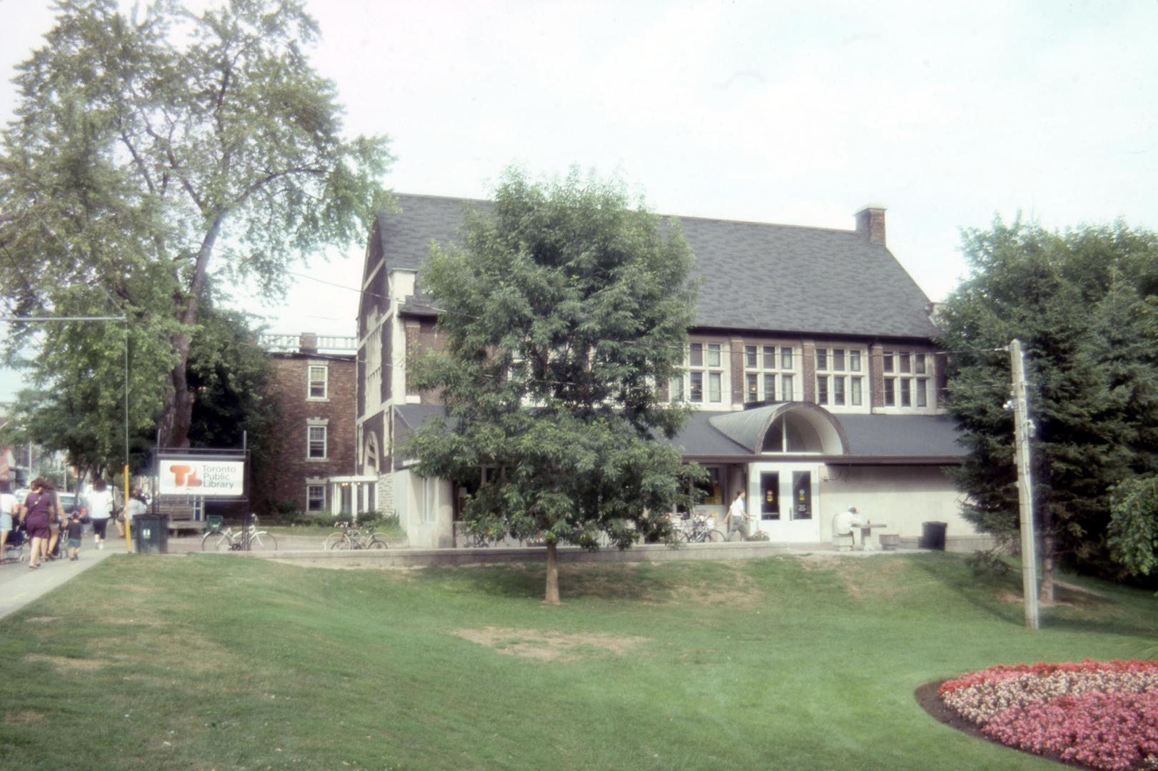 Exterior view of a public library with Toronto Public Library sign at front. 