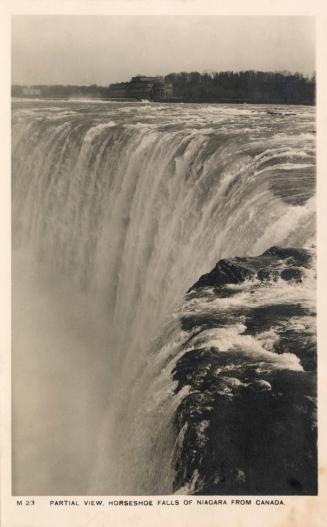 Black and white photograph of water cascading over the top of a cliff.