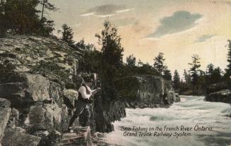 Colorized photograph of a man holding a bent fishing pole over rapidly flowing water in a river…